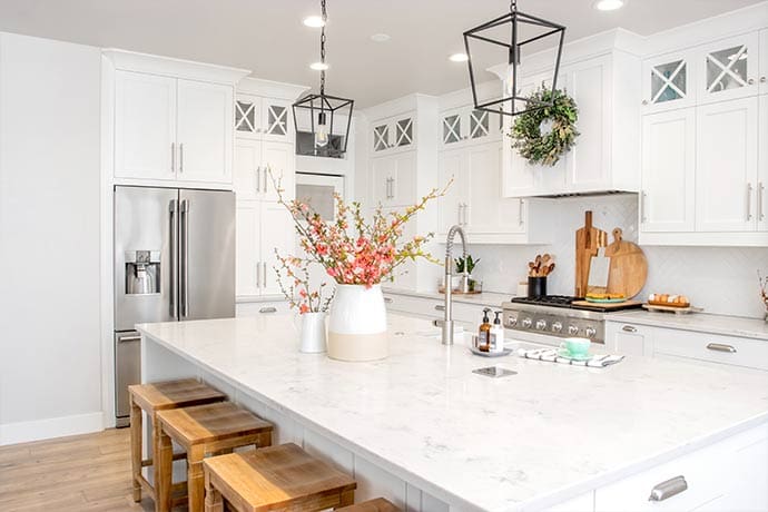 white quartz countertops in a modern, all-white kitchen