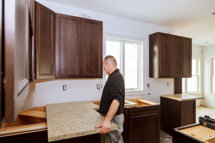 Professional performing a marble countertop installation