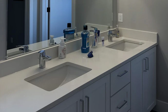 A newly installed his and hers sink in a remodeled bathroom